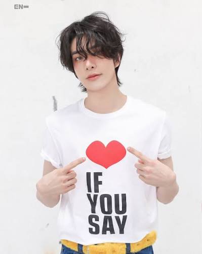 Person wearing a white tee with a red heart and IF YOU SAY print